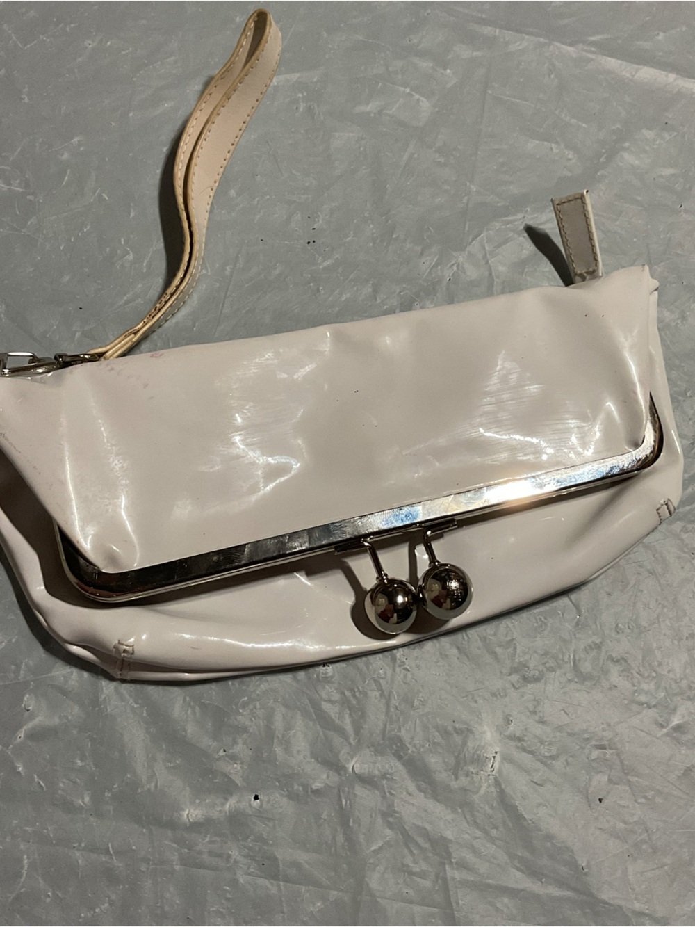 Women’s Cream Patent Clutch Wristlet  a small stain